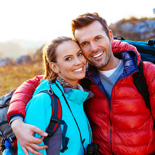 FAQs Couple Hugging on a Hiking Trail