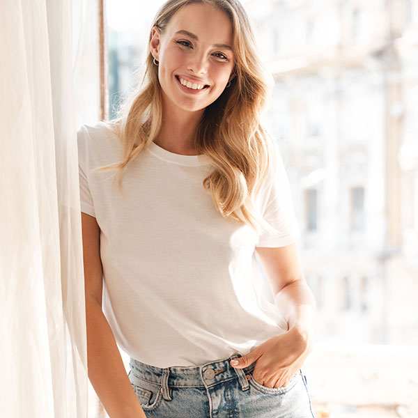 Patient Forms Young Blonde Woman Standing Beside Window